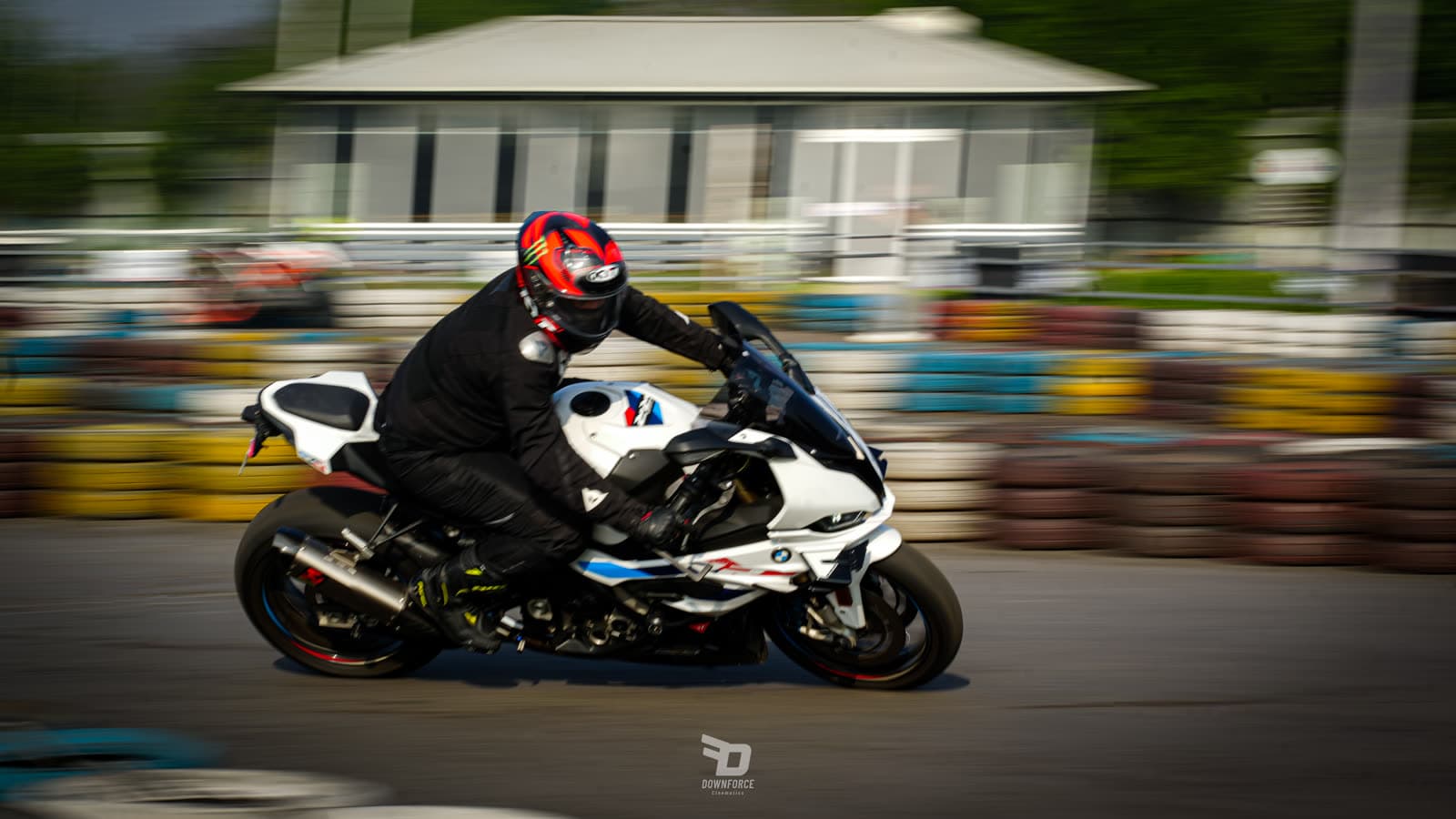 Rider cornering a BMW S1000RR between tyre barriers